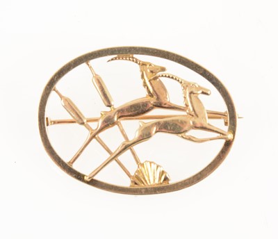 Lot 1237 - Geoffrey Bellamy for Ivan Tarratt a 9 carat yellow gold leaping gazelle brooch.