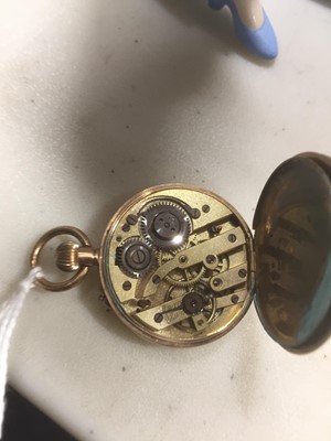 Lot 1362 - A yellow metal open face fob watch.