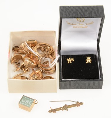 Lot 1239 - A collection of gold earrings, emergency £1 charm, tie pin, bar brooch, stick pin.