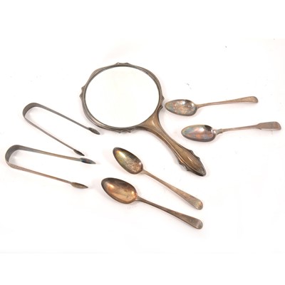Lot 167 - Seven Georgian silver table spoons, two silver sugar tongs and a silver-mounted hand mirror.