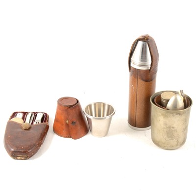 Lot 271 - A small collection of stirrup cups and canteens in leather holders.