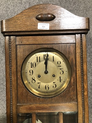 Lot 523 - An oak cased wall clock