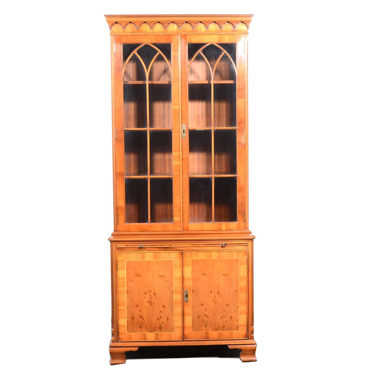 Lot 143 - A reproduction yew wood bookcase and a reproduction mahogany finish freestanding corner cupboard