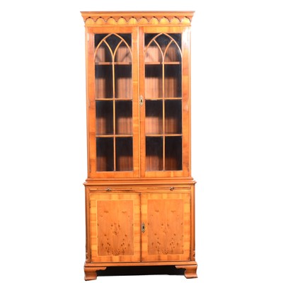 Lot 143 - A reproduction yew wood bookcase and a reproduction mahogany finish freestanding corner cupboard