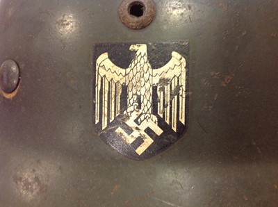 Lot 113 - WWII German steel war helmet with side decals.