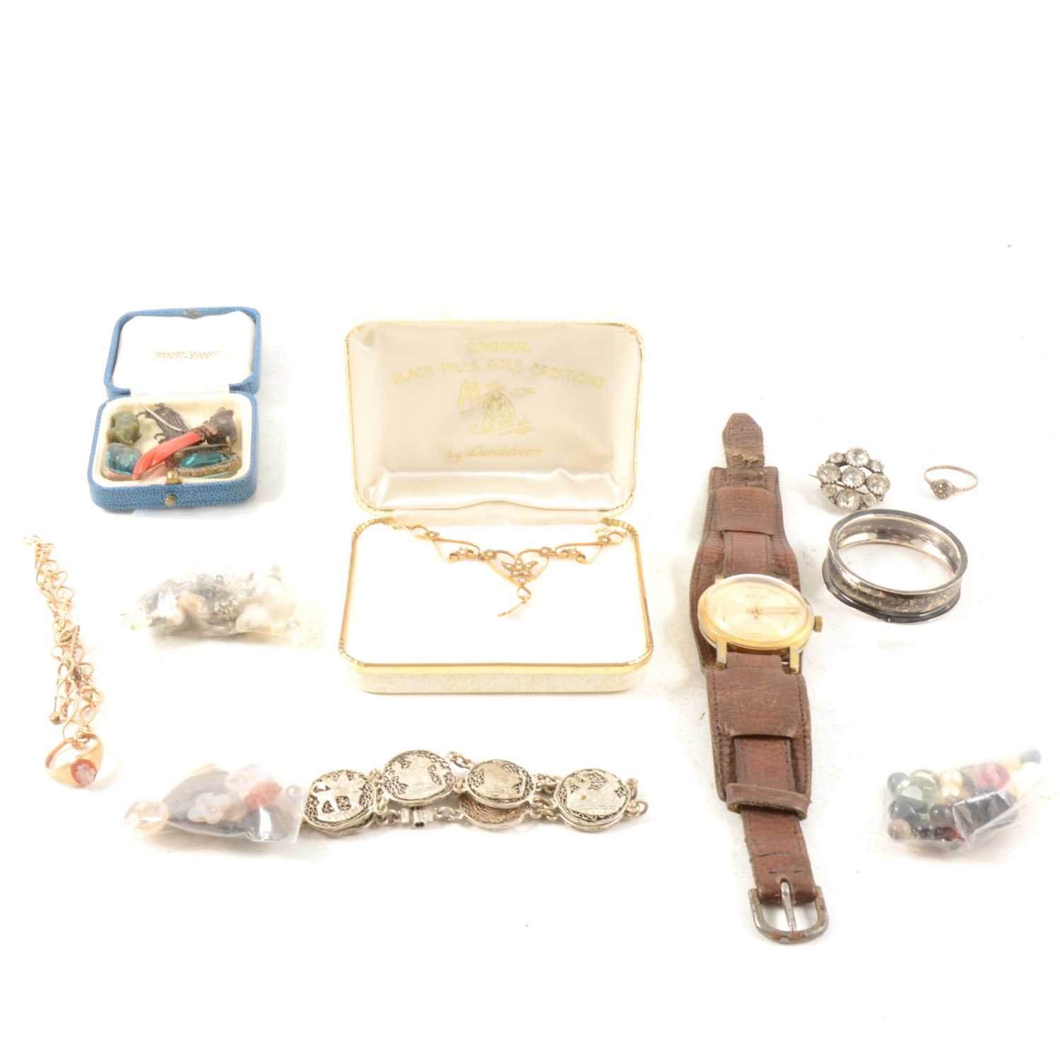 Lot 128 - 9ct. gold rope link bracelet, a 9ct. Cameo ring, a pendant marked 14k. together with a silver napkin ring, an Egyptian bracelet, a wristwatch and a quantity of loose stones etc.