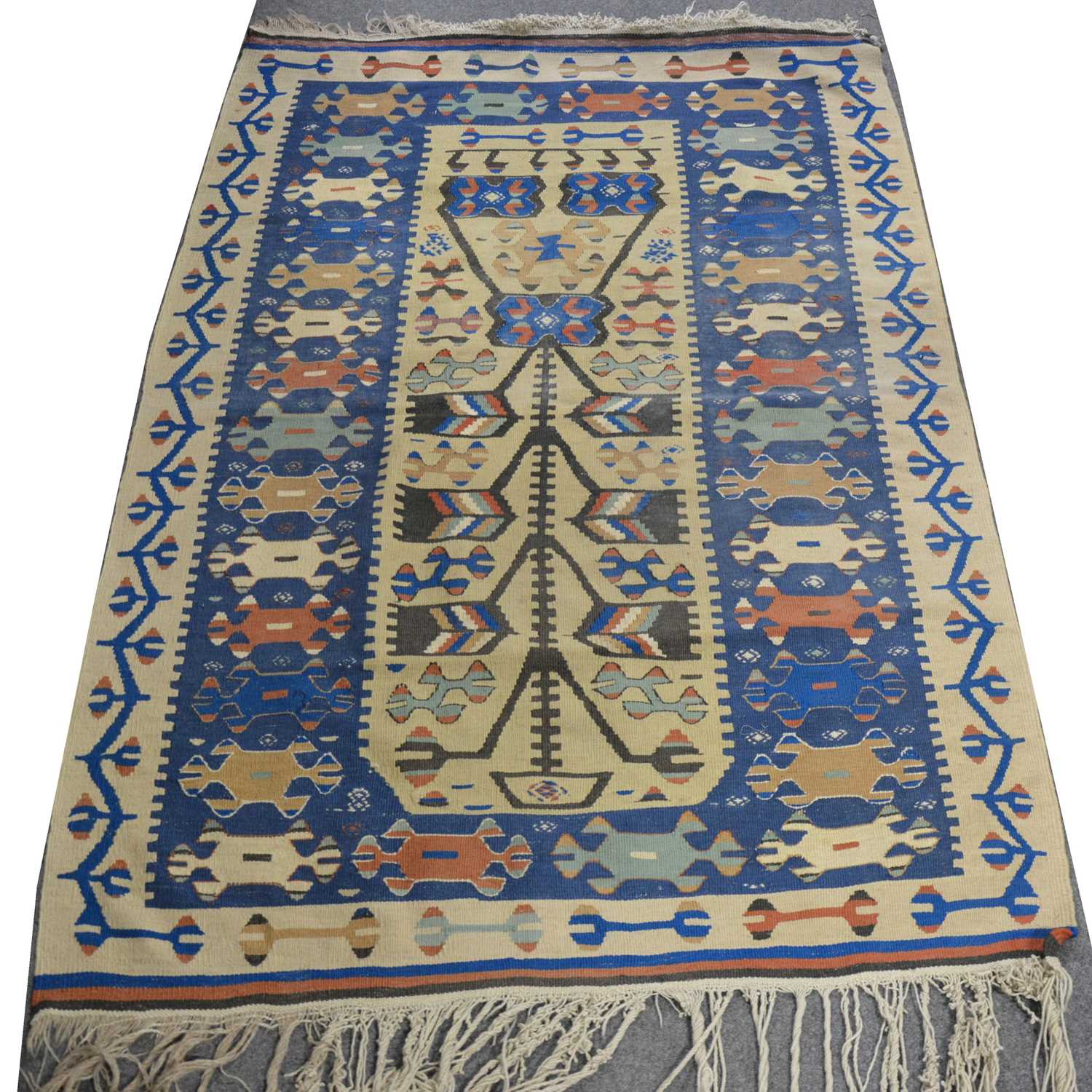 Lot 133 - Kilim carpet, beige and blue ground with geometric patterns