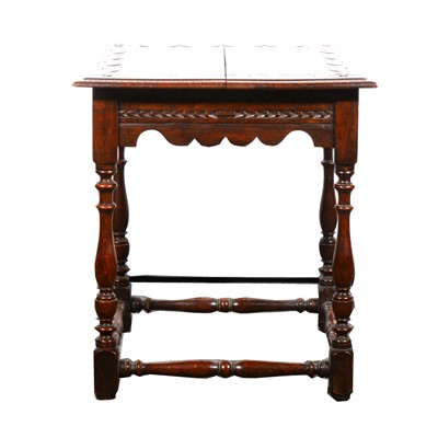 Lot 554 - A Victorian carved oak lamp table