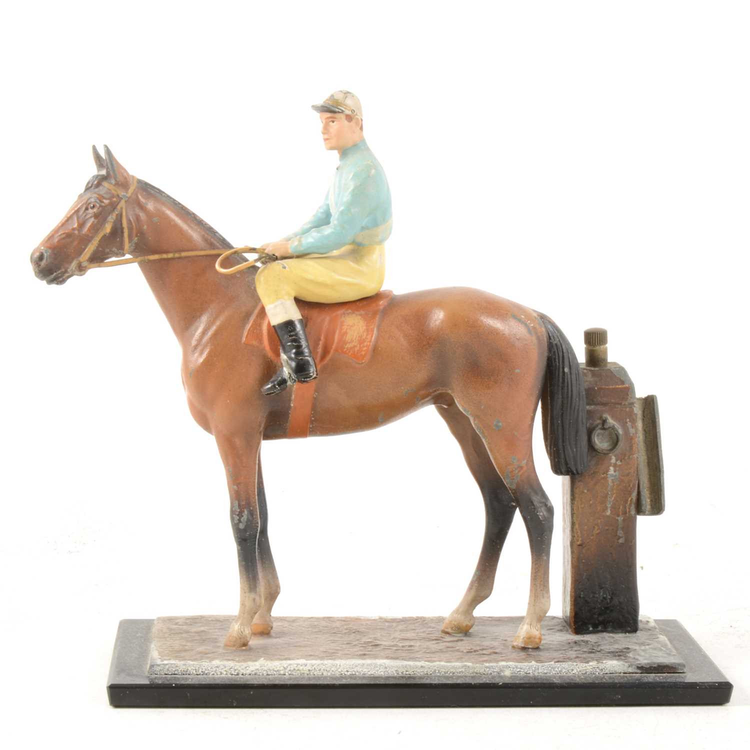 Lot 147 - A cold-painted spelter match striker in the form of a racehorse with jockey