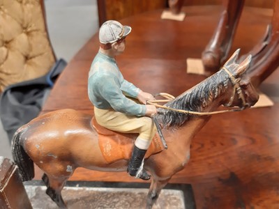 Lot 147 - A cold-painted spelter match striker in the form of a racehorse with jockey