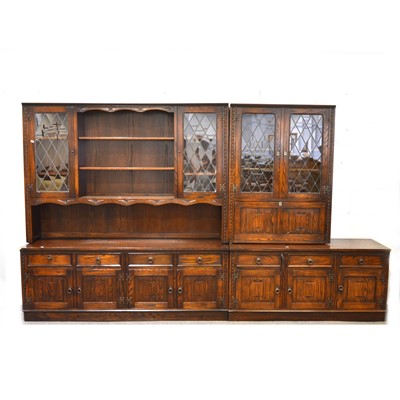 Lot 555 - A reproduction stained oak dresser with leaded glazed cupboards, and similar side cabinet/ bookcase