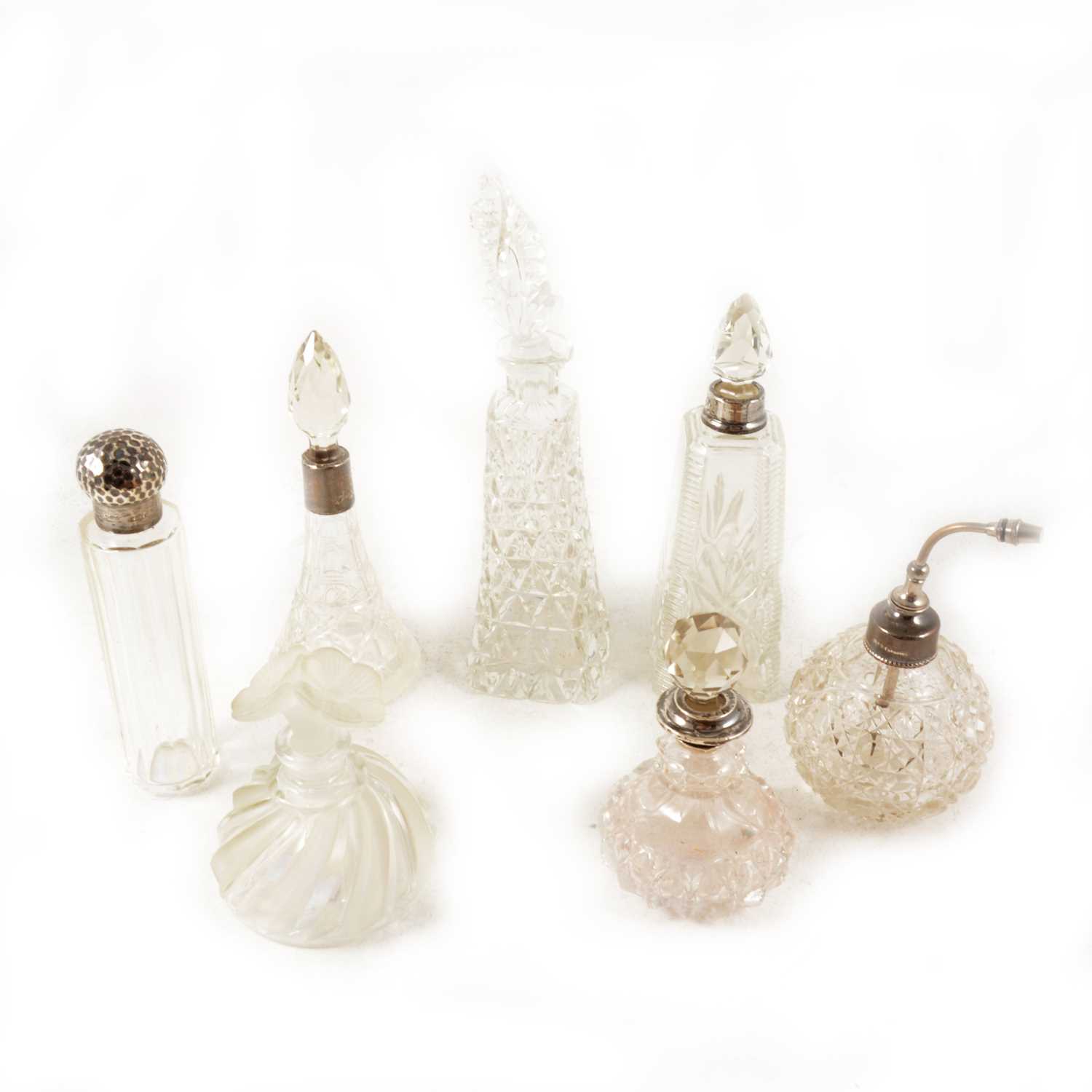 Lot 142 - A collection of glass scent bottles and atomisers, many silver or metal mounted.