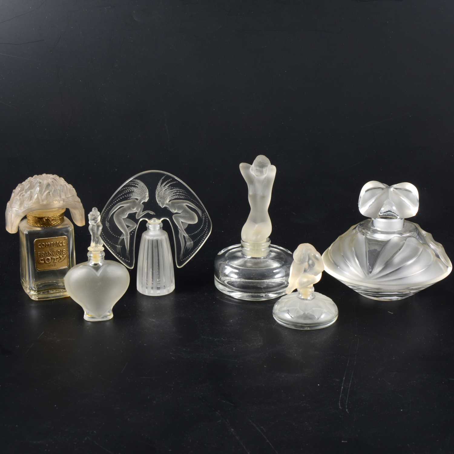 Lot 143 - A collection of glass scent and perfume bottles, including post-1945 Lalique