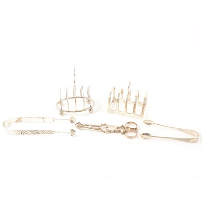 Lot 316 - A small quantity of silver and white metal items, including toast racks and sugar tongs.