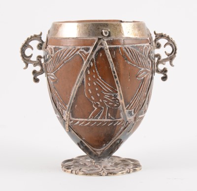 Lot 90 - A white metal mounted coconut cup of ovoid form, pricked date 1590