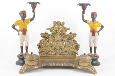 Lot 218 - A pair of cast metal and cold painted Blackamoor candlesticks, 27cm