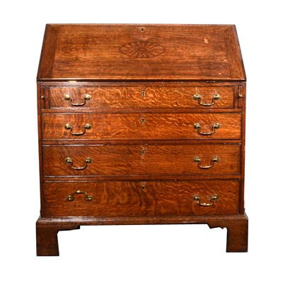 Lot 568 - A Georgian oak bureau, later incised...