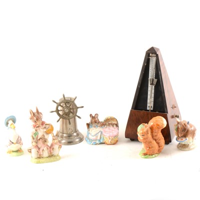 Lot 101 - A German table-lighter in the form of a ship's wheel; metronome, and Beatrix Potter figures