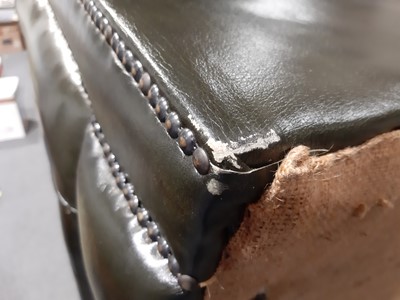 Lot 411 - A modern two-seater leather settee in the Chesterfield style
