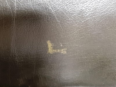 Lot 411 - A modern two-seater leather settee in the Chesterfield style