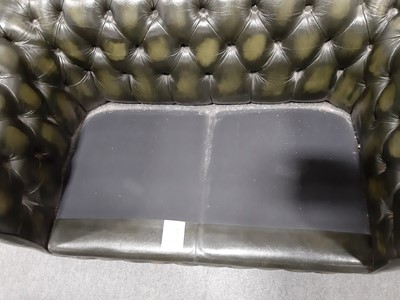 Lot 411 - A modern two-seater leather settee in the Chesterfield style