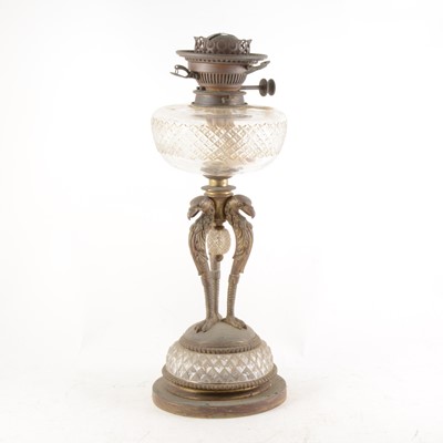Lot 143 - A gilt metal and cut-glass oil lamp, with Griffin head monopods