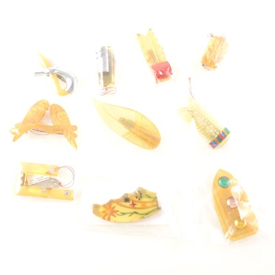 Lot 305 - Ten Art Deco lucite dress clips and brooches, mostly in the "apple juice" and "lemon" colours.