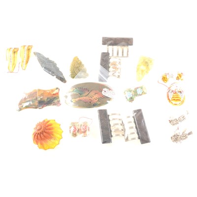 Lot 303 - A collection of bakelite and early plastic brooches, buckles and clips - various colours.