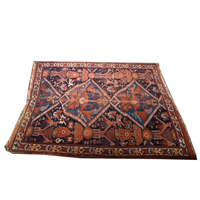 Lot 638 - An old Caucasian rug, two joined medallions on...