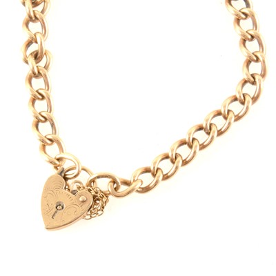 Lot 375 - A 9 carat yellow gold solid curb link charm bracelet with padlock fastener.