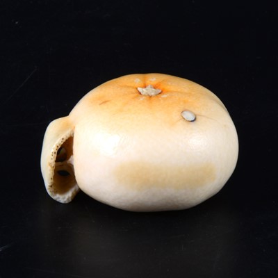 Lot 38 - A Japanese carved and stained ivory model of a part-peeled satsuma, early 20th Century