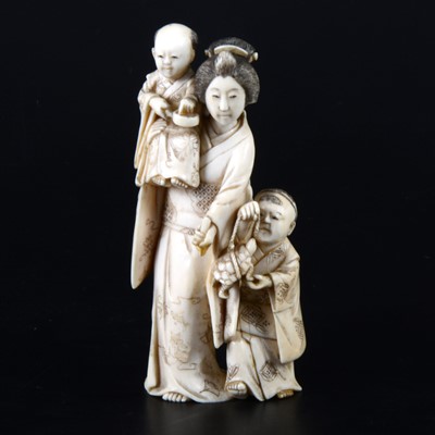 Lot 56 - A small Japanese carved and stained  ivory group, probably early 20th Century