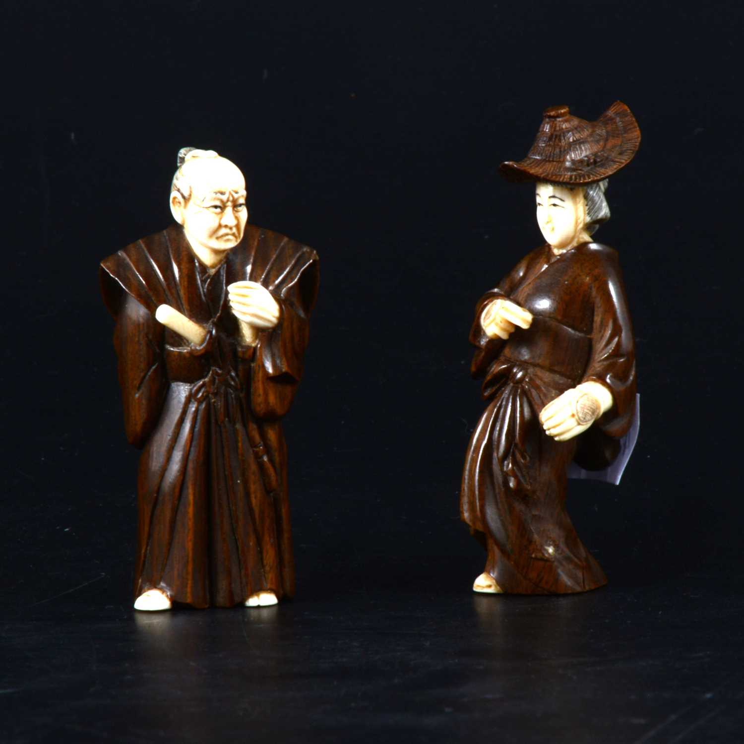 Lot 62 - Two Japanese carved wood nesuke's with ivory detail