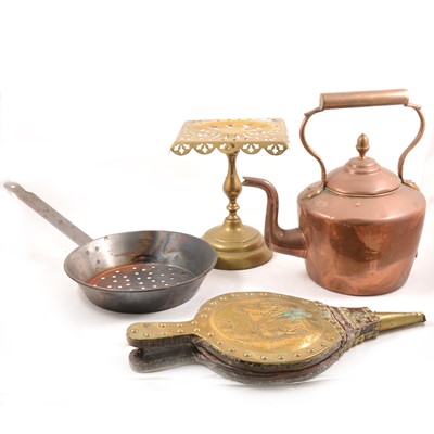 Lot 255 - A quantity of brass and copper wares, to include a gunpowder flask, kettle, candlesticks, bellows etc.