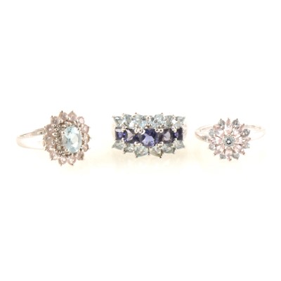 Lot 333 - Three 9 carat white gold dress rings set with blue topaz.