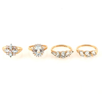 Lot 337 - Four 9 carat yellow and white gold dress rings set with blue topaz.