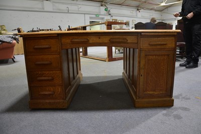 Lot 71 - An Edwardian oak twin pedestal partners desk.
