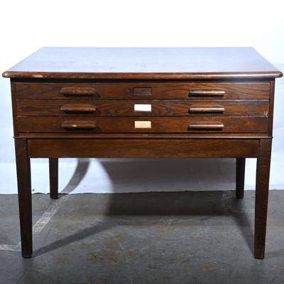 Lot 149 - A stained oak three drawer plan chest.