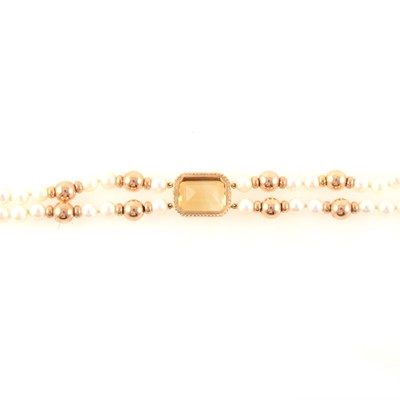 Lot 398A - A two row rope of cultured pearls with gold and citrine adornment.