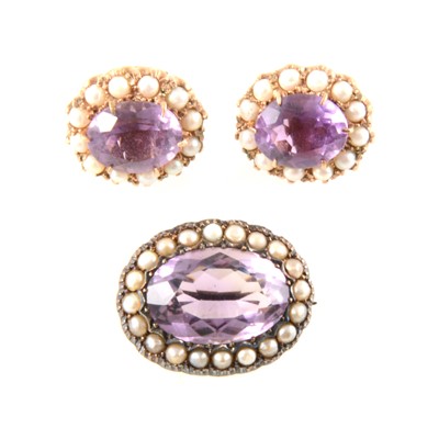 Lot 356 - An amethyst and seed pearl oval brooch and pair of similar earrings for pierced ears.