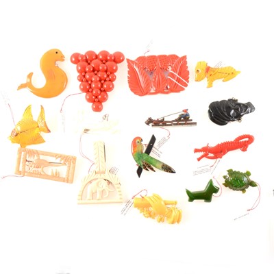 Lot 299 - Fifteen vintage celluloid/bakelite/plastic novelty brooches and clips.