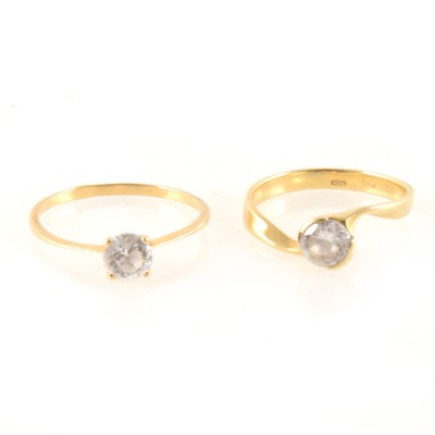 Lot 349 - Two yellow metal solitaires marked 750 set with synthetic white stones.