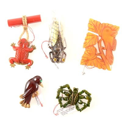 Lot 300 - A French lucite cicada brooch, bar brooch with frog fob and a carved bird in a tree brooch, plus two others.