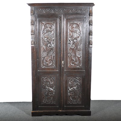 Lot 505 - A carved oak two door wardrobe