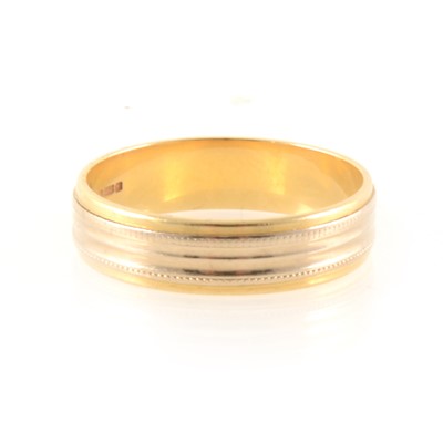 Lot 345 - An 18 carat yellow and white gold wedding band.