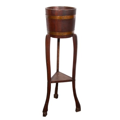 Lot 567 - An oak jardiniere stand, barrel-like, tripod...