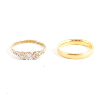 Lot 376 - A 22 carat yellow gold wedding band and diamond three stone ring.