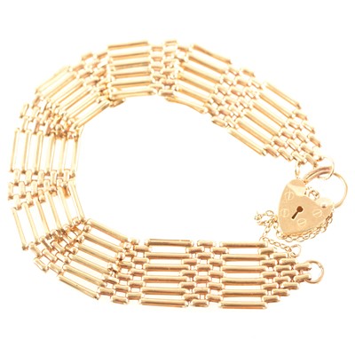 Lot 255 - A 9 carat yellow gold six bar gate link bracelet.