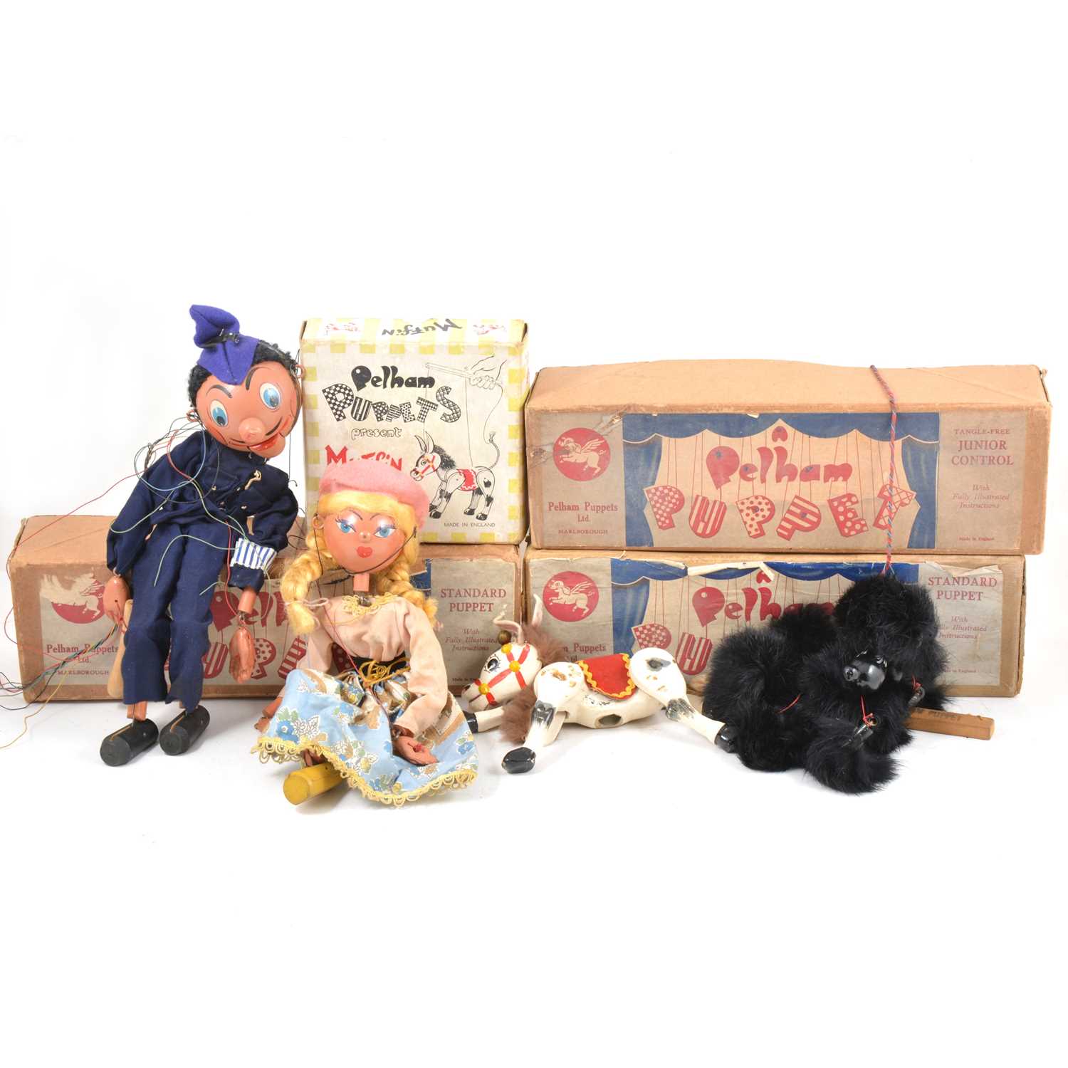 Lot 13 - Pelham Puppets; four including black poodle, police man, girl and Muffin the Mule, all boxed.