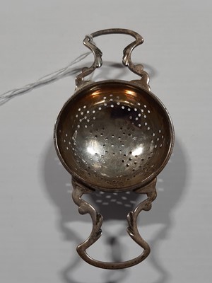Lot 181 - A silver tea strainer and stand by Asprey & Co.